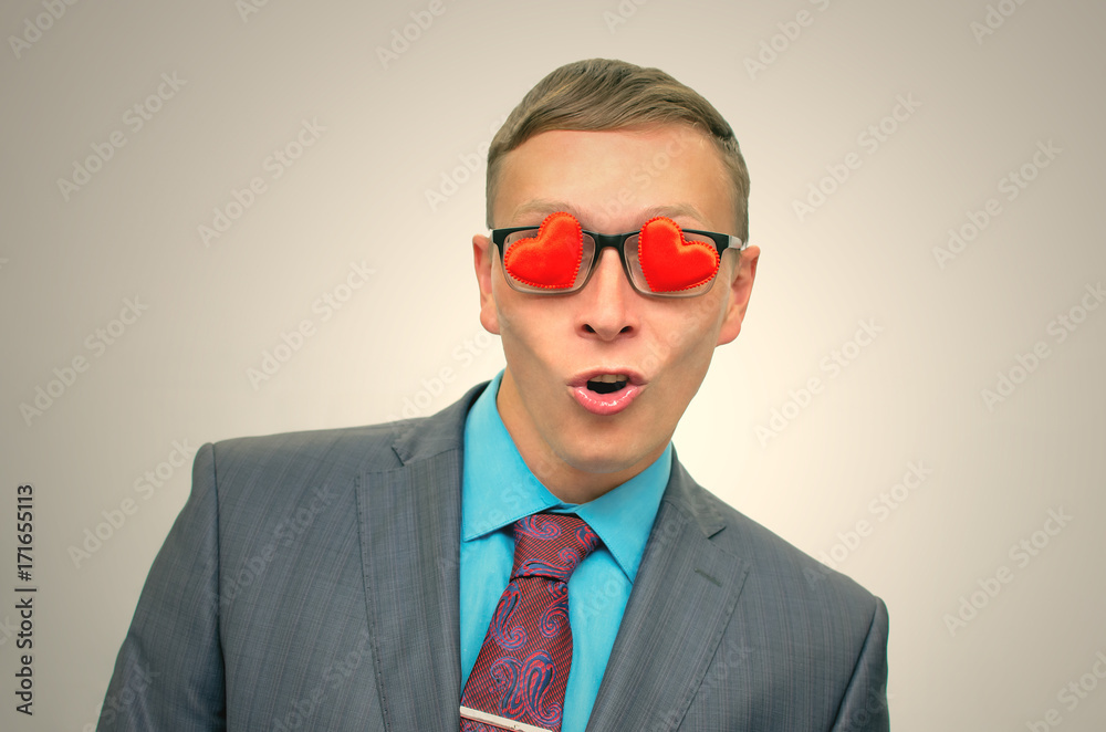 Fall in love. Womanizer man. Ladies man. Womanizer man in suit, heart shape glasses and wide open mouth looking on beautiful sexy woman. Fall in love. Womanizer man. Ladies man. Womanizer man in suit, heart shape glasses and wide open mouth looking on beautiful sexy woman.