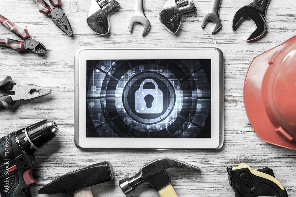 Web security and technology concept with tablet pc on wooden tab Web security and technology concept with tablet pc on wooden tab