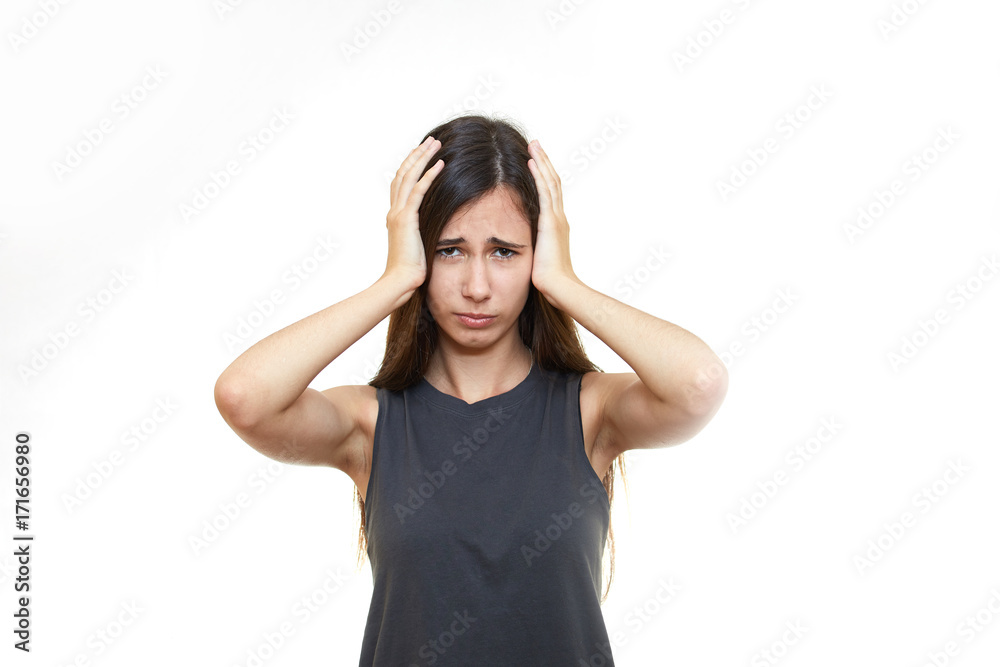 Girl emotions. White background. Portrait of young angry shocked woman holding head Girl emotions. White background. Portrait of young angry shocked woman holding head