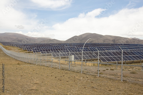 solar farm in the mountains under the cloudy sky