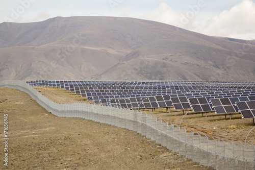 solar farm in the mountains under the cloudy sky