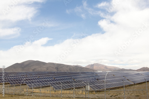solar farm in the mountains under the cloudy sky