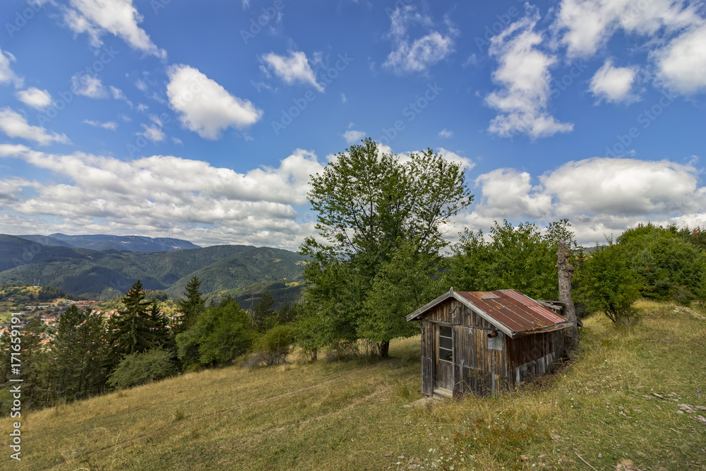 beauty daily landscape of alone old wooden house on a hill in a mountain