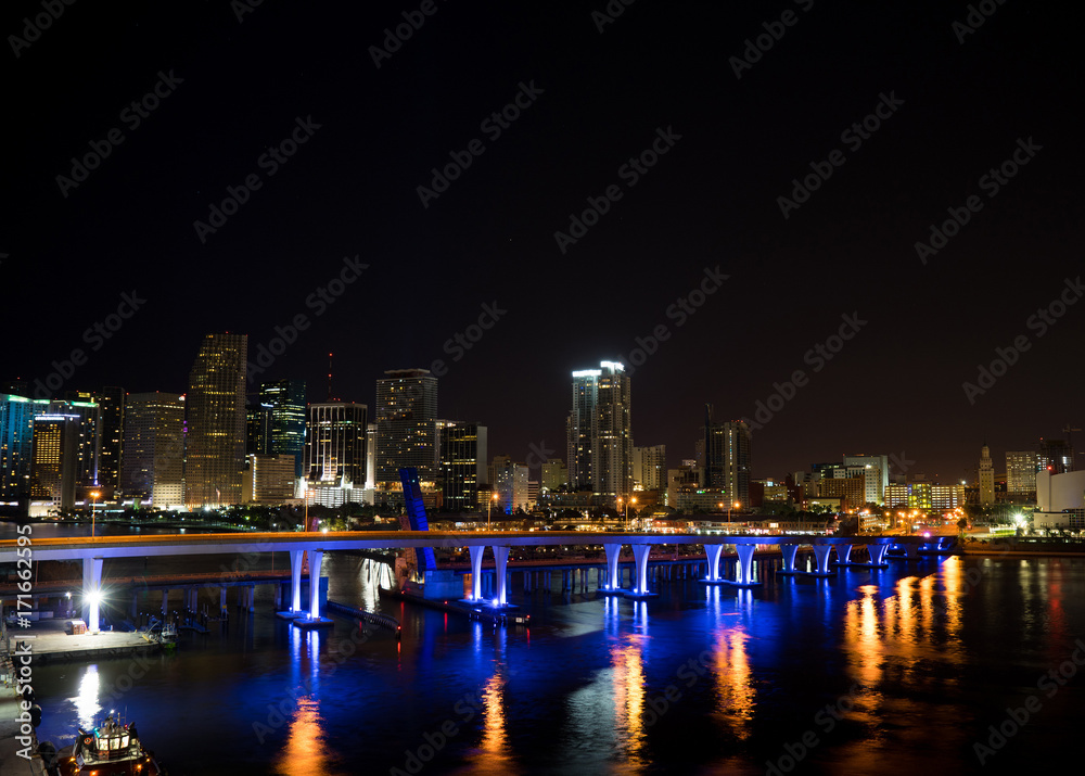Fototapeta premium Miami at night. View from atop a glowing building with a bridge