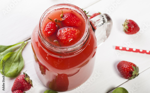 Strawberry smoothie or milkshake in a jar on white background.
