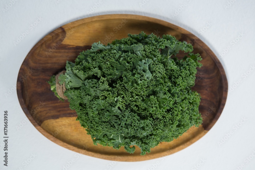 Overhead view of fresh kale in wooden plate Overhead view of fresh kale in wooden plate