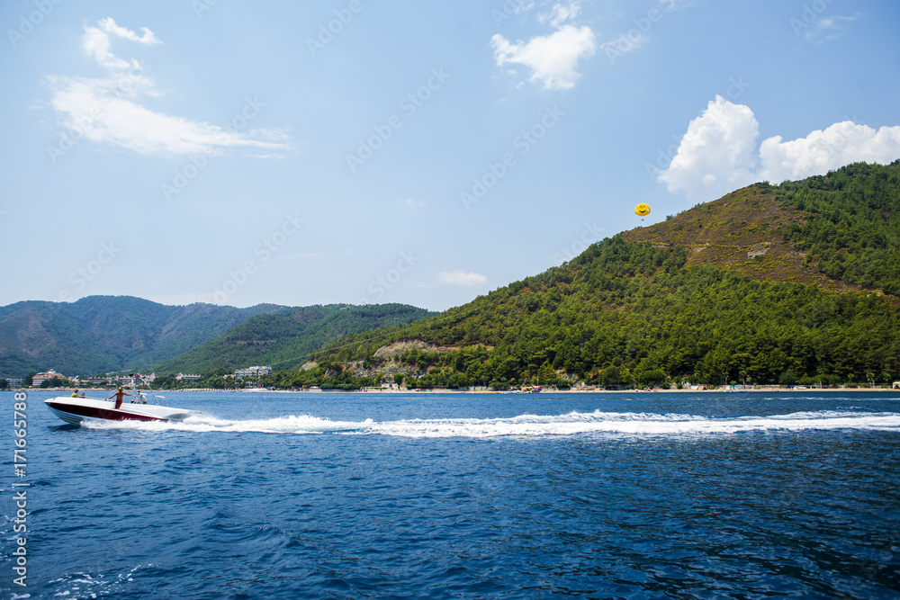 Parasailing on the sea from fast motor boat