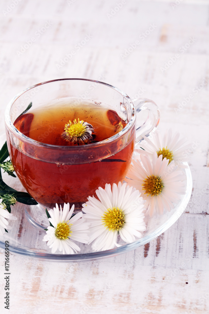 cup of tea with chamomile flowers on rustic background cup of tea with chamomile flowers on rustic background