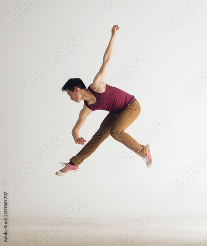 Young asian male dancer mid-air