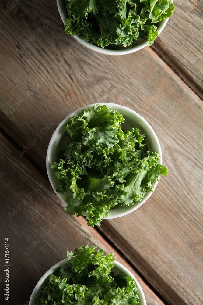 Overhead view of kale arranged in bowls on table Overhead view of kale arranged in bowls on table