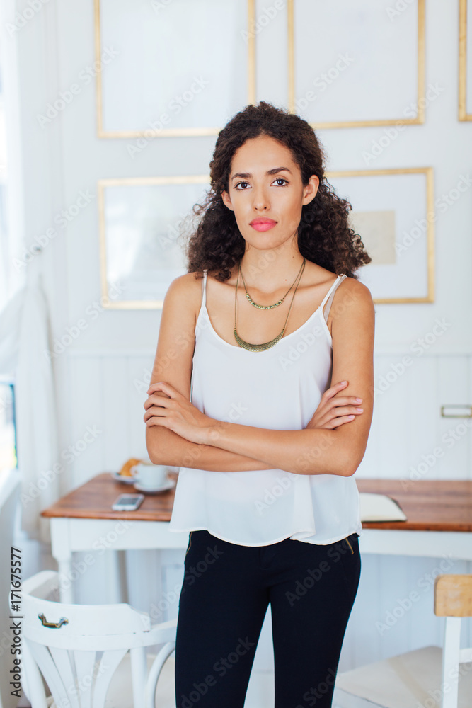 Portrait of a young businesswoman standing in a coffee bar. Portrait of a young businesswoman standing in a coffee bar.