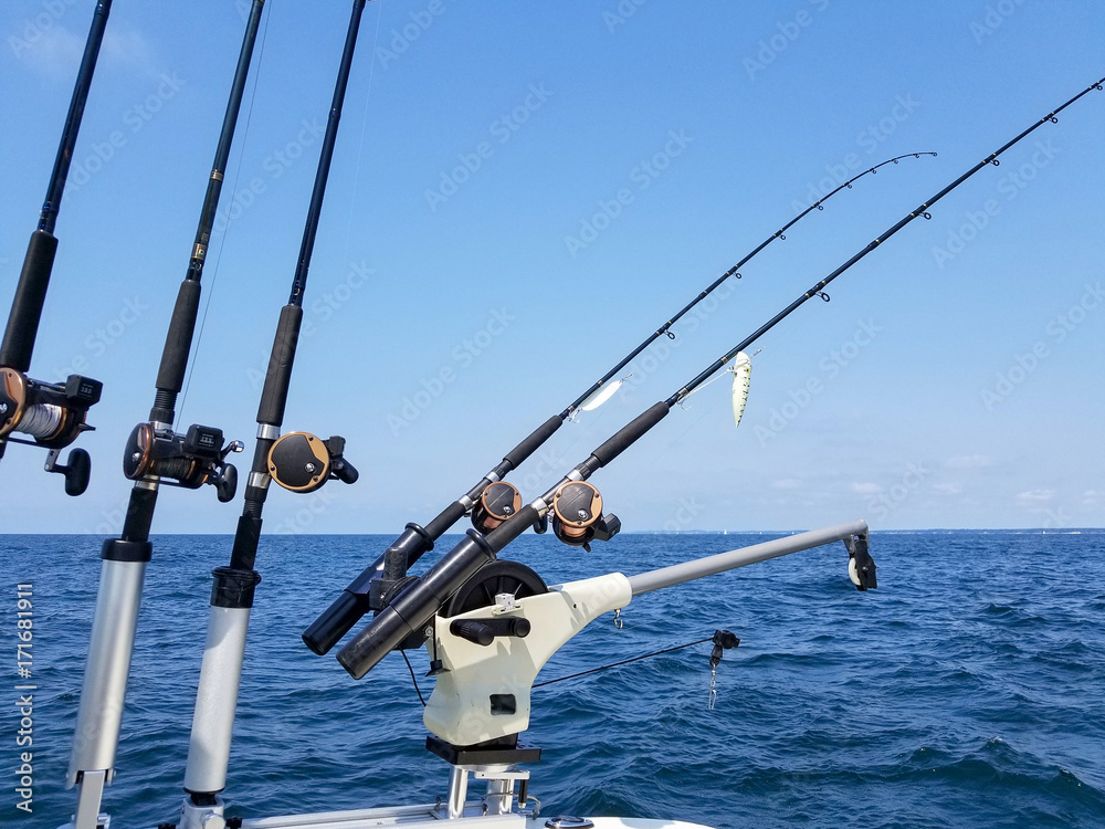 fishing rods and reels with lure on boat on Lake Michigan