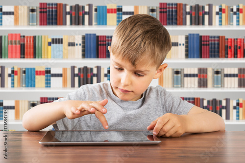 Boy Using Digital Tablet At School