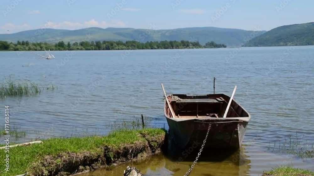 Moored boat by the shore and fresh,clean water Moored boat by the shore and fresh,clean water