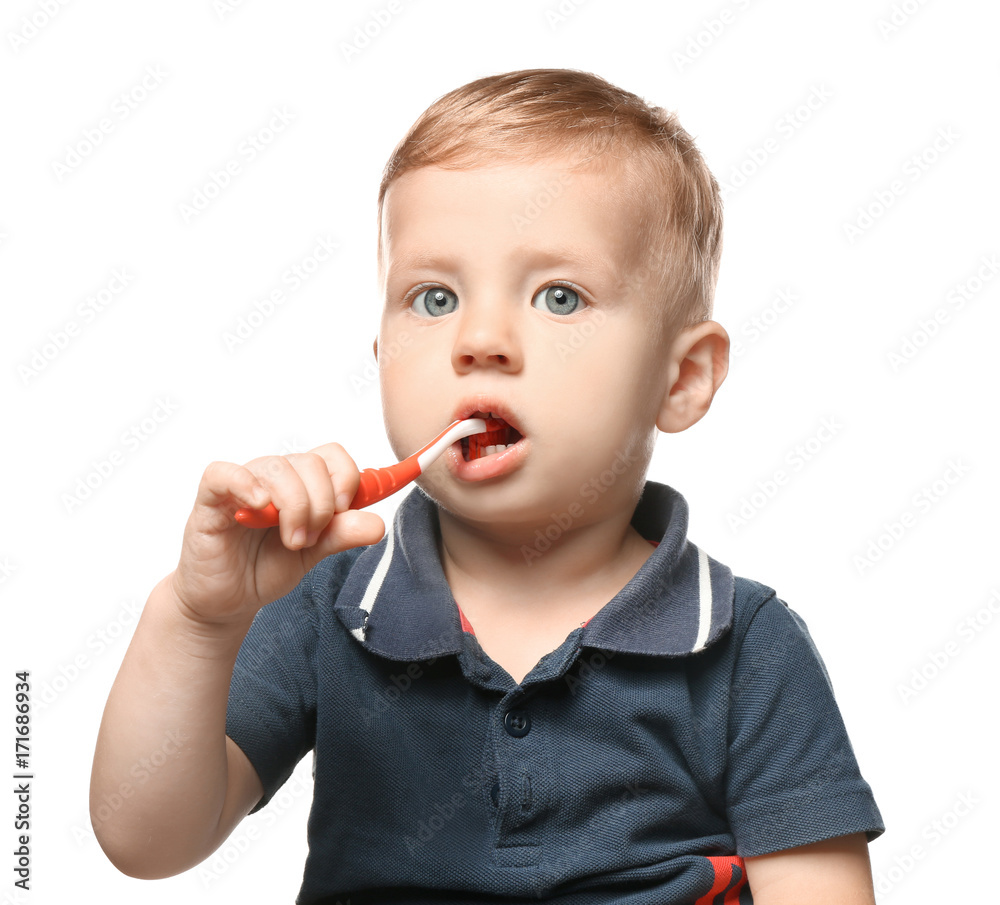 Adorable little boy brushing teeth on white background Adorable little boy brushing teeth on white background