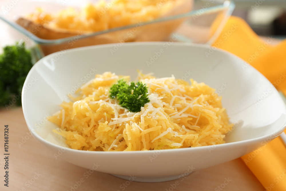 Plate with spaghetti squash on table Plate with spaghetti squash on table