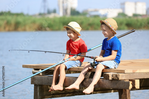 Cute children fishing on su...