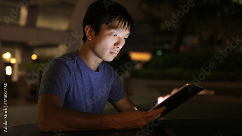 Asian Man use of tablet computer © leungchopan