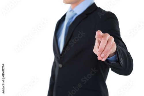 Mid section of businessman gesturing on invisible interface