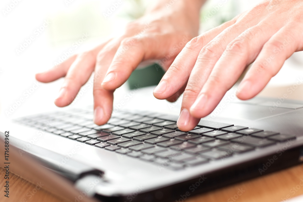 Hands on the laptop keyboard close-up Hands on the laptop keyboard close-up