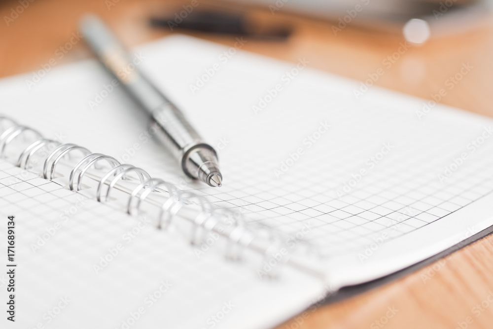 Ballpoint pen lying on the notebook closeup Ballpoint pen lying on the notebook closeup