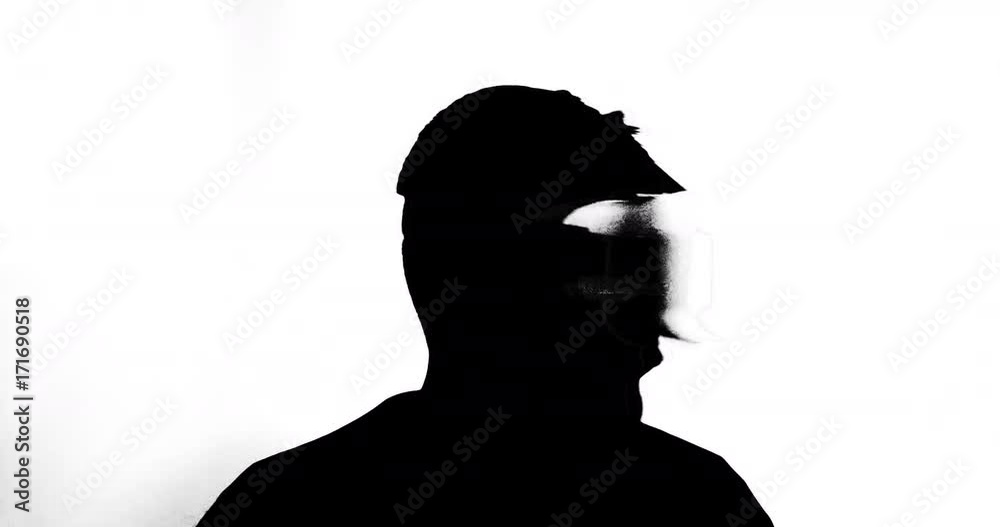 Silhouette of a male wearing VR headset and looking around the screen Silhouette of a male wearing VR headset and looking around the screen