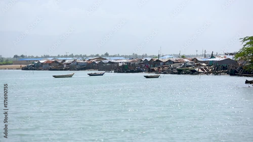 Wide angle view of low income houses built up along the shore in Port-au-Prince