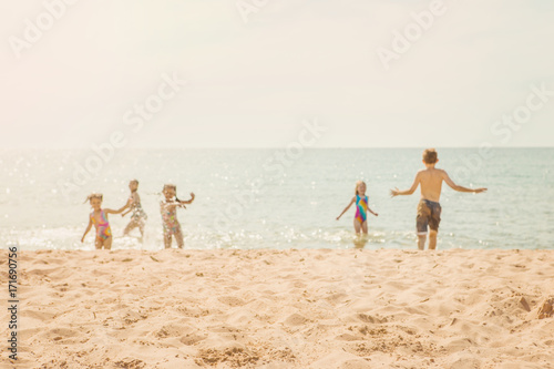Kids playing at the beach, blurred image