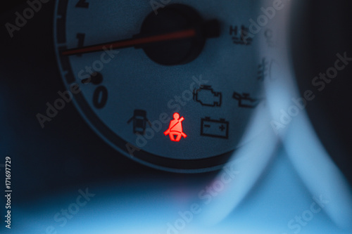 car safety belt or seatbelt red light warning sing show at vehicle gauge photo