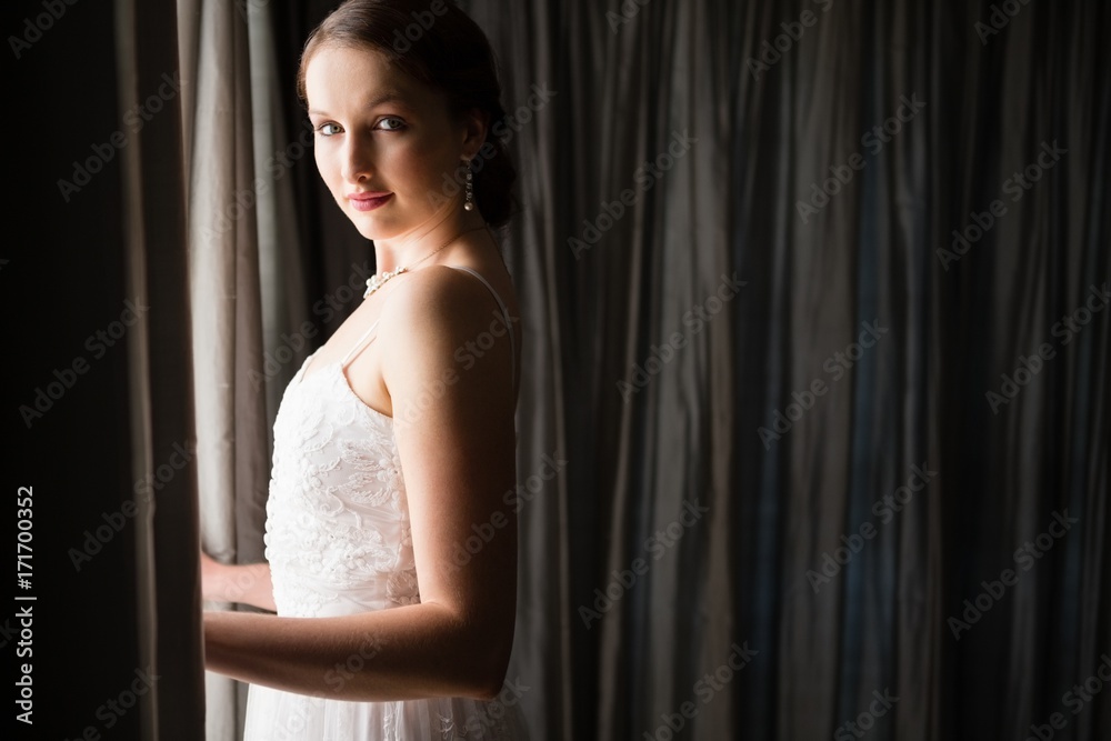Portrait of beautiful bride standing by window at home Portrait of beautiful bride standing by window at home