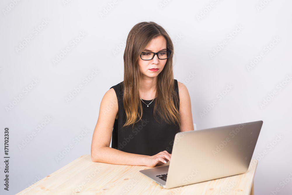 business concept - businesswoman working on laptop in the office business concept - businesswoman working on laptop in the office