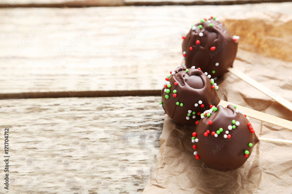 Chocolate cake pops on grey wooden table