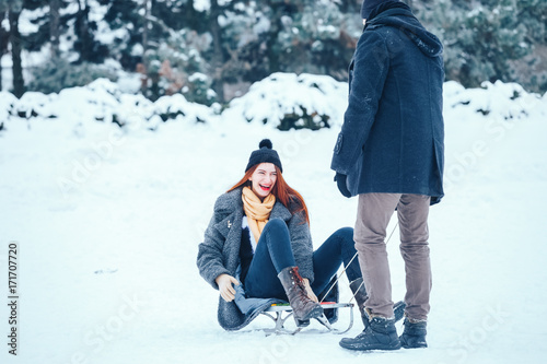young couple in love enjoying a winter vacation and having fun on a snowy winter day.