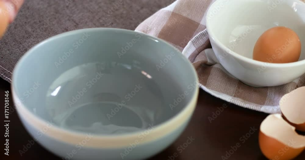 Close up chef hand braking an egg into a blue bowl then mix to prepare omelet cooking , 4k Dci resolution Close up chef hand braking an egg into a blue bowl then mix to prepare omelet cooking , 4k Dci resolution
