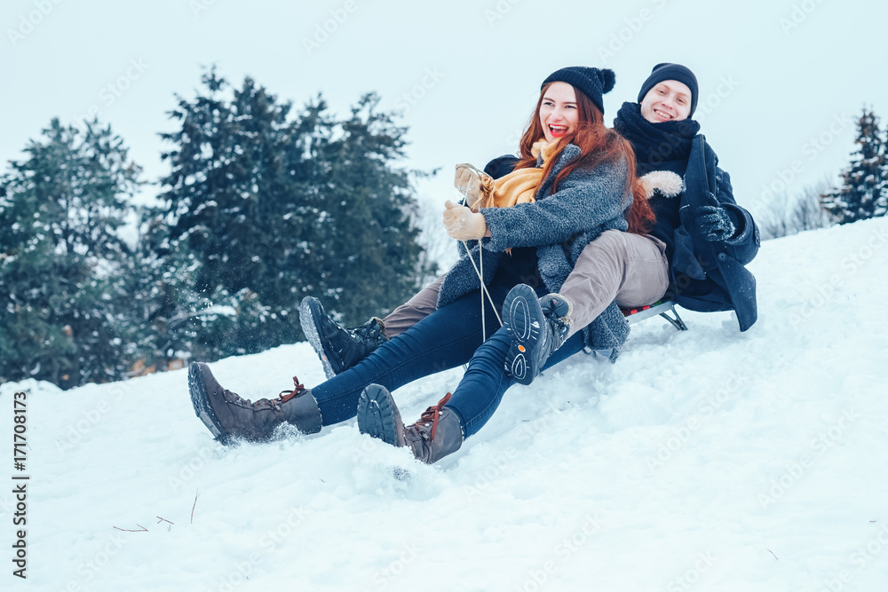 Fototapeta premium young couple in love enjoying a winter vacation and having fun on a snowy winter day.