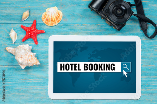 hotel booking searching, website page opened in digital tablet lying on turquoise table