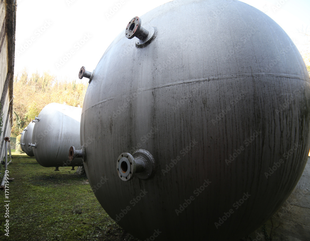 Huge gas storage tanks in an industrial area. Huge gas storage tanks in an industrial area.