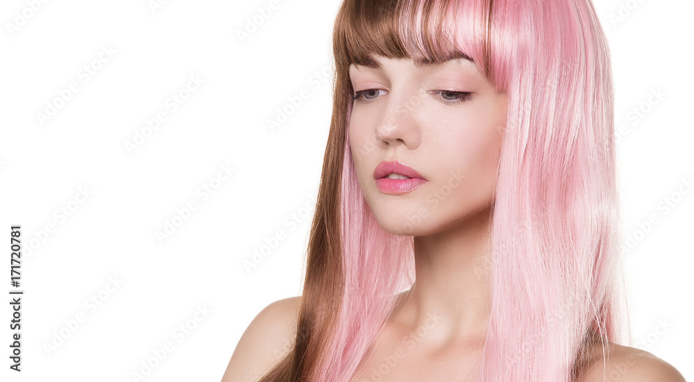Naklejka premium Girl with a doll with pink hair. The wig is brownish-pink. Delicate, airy, natural make-up. White background.