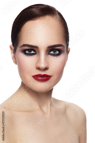 Young beautiful elegant woman with smoky eye make-up and red lips over white background  copy space