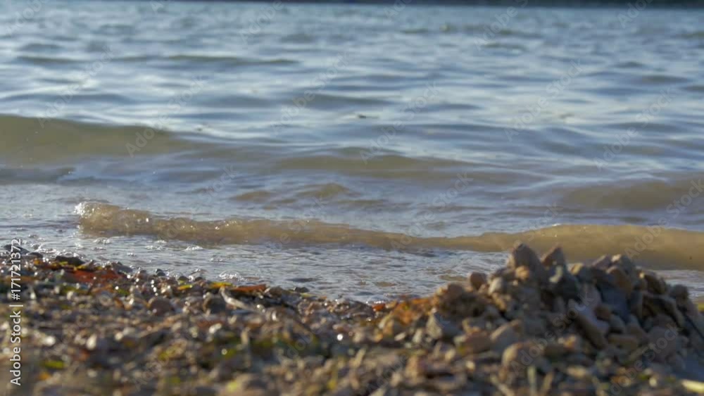 close-up on waves splashing sandy beach at beautiful sunset. in slow-motion hd close-up on waves splashing sandy beach at beautiful sunset. in slow-motion hd