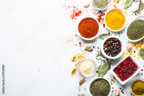 Fototapeta Naklejka Na Ścianę i Meble -  Set of spices in a bowls on white background. Top view copy space.