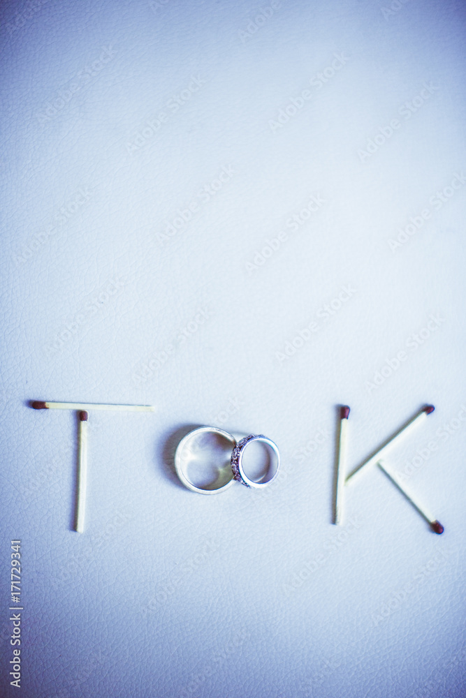 Matches and wedding rings make a word 'Took' on a table Matches and wedding rings make a word 'Took' on a table