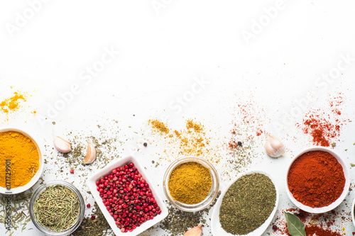 Fototapeta Naklejka Na Ścianę i Meble -  Various spices in a bowls on white background. Top view copy space.