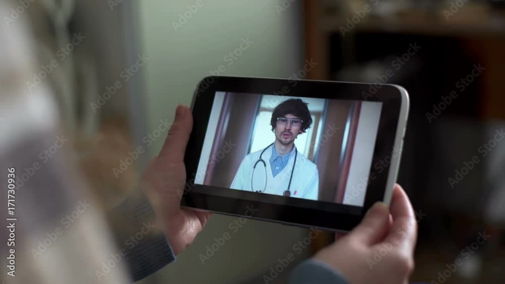 Woman In Kitchen Using Tablet - Online Chat with Doctor on Screen Woman In Kitchen Using Tablet - Online Chat with Doctor on Screen