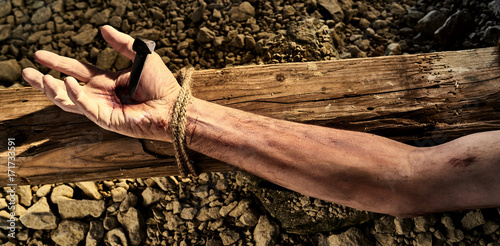 Arm of Christ nailed to a wooden cross photo