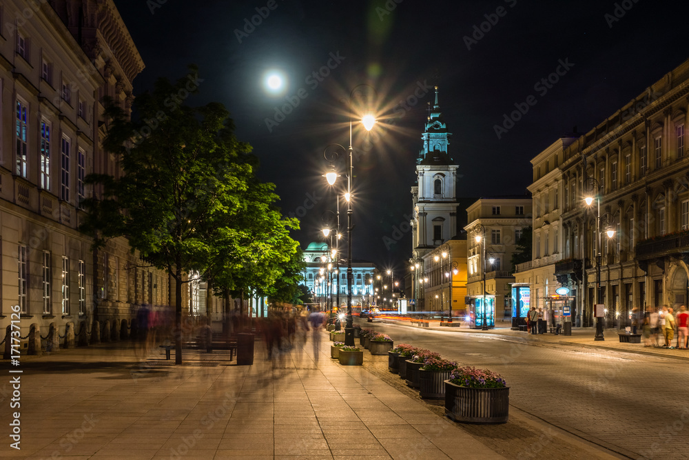 Church of the Holy Cross on Krakowskie Przedmiescie street at night in Warsaw, Poland