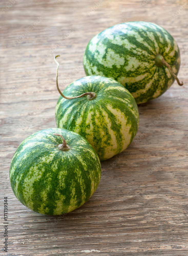 Tasty watermelons on brown wooden background