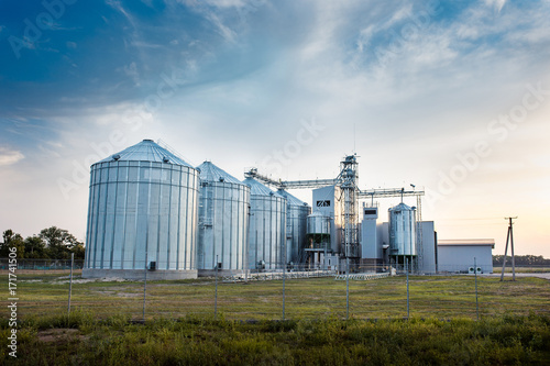 Big group of grain dryers complex for drying wheat. Modern grain silo. Agriculture concept.