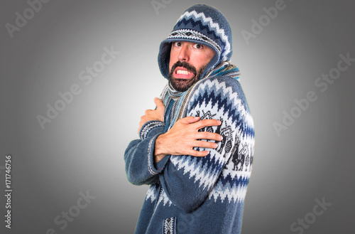 Photography freezing man with winter clothes on grey background