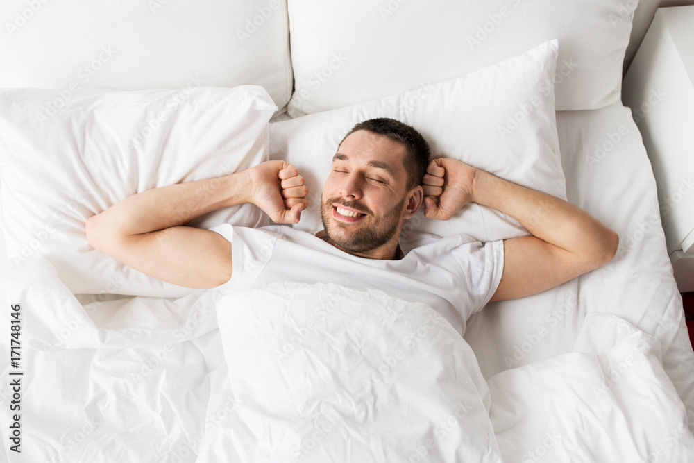 man lying in bed at home man lying in bed at home